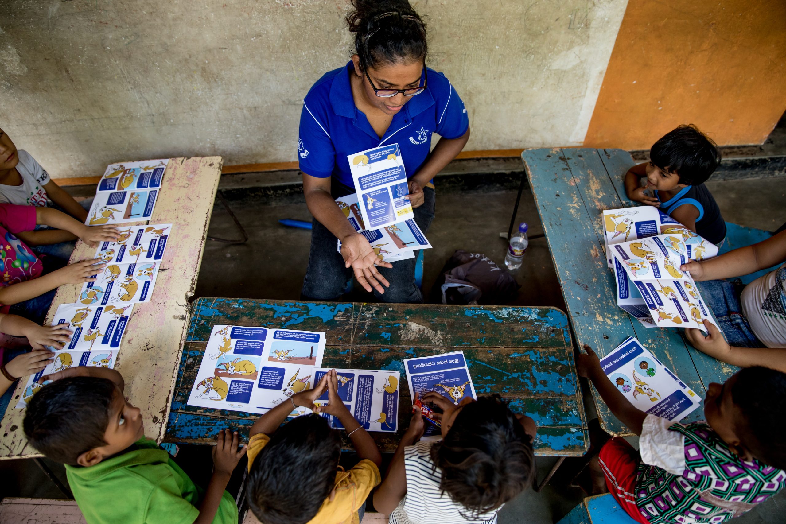 A Dogstar employee teaching a group of children.